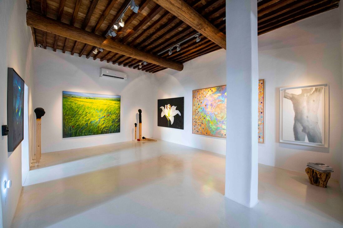 Interior of Minima Gallery in Mykonos Town with contemporary artworks on white walls